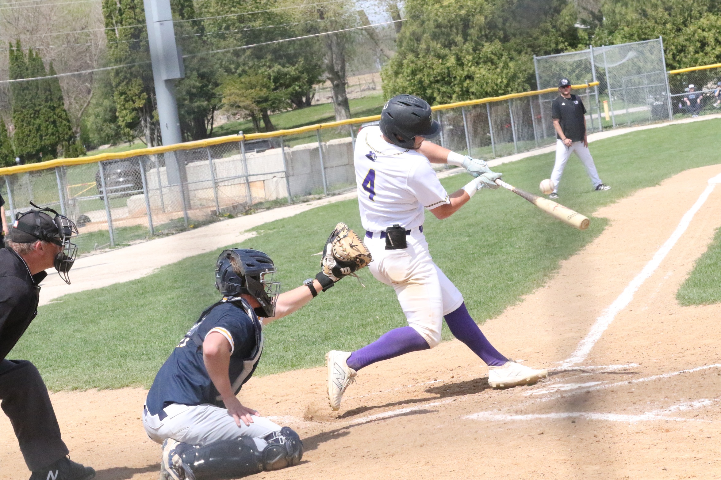 Sophomore Eric McGill puts the ball in play at the plate. Photo by Justin Ites, The Times Citizen.